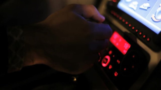 Man hand shifting gears while driving car. Car driving with manual transmission. Close up of changing gears with gearbox knob of manual transmission. Gear shift. Auto dashboard lights