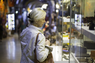 Middle aged woman in storefront shopping in Grand Bazaar,Istanbul