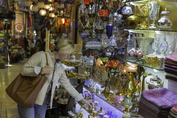 Middle aged woman in storefront shopping in Grand Bazaar,Istanbul