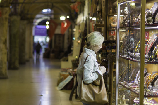 Middle aged woman in storefront shopping in Grand Bazaar,Istanbul