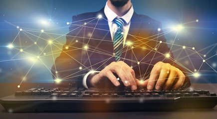 Man typing with connection graphics around