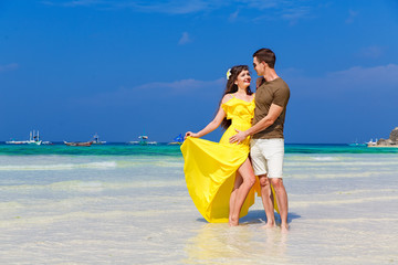 Couple having fun on tropical beach. Summer vacation concept.