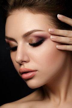 Portrait of young beautiful woman with evening make up