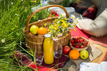 picnic on the grass. juice, a bouquet of wild flowers, fruit,Picnic at the park on the grass,healthy food and accessories,Picnic Grass Summer Time Rest