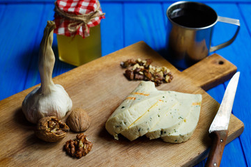Slices of spicy cheese, served with walnuts,garlic and mug of homemade wine.