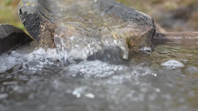 Water flowing in old wooden groove