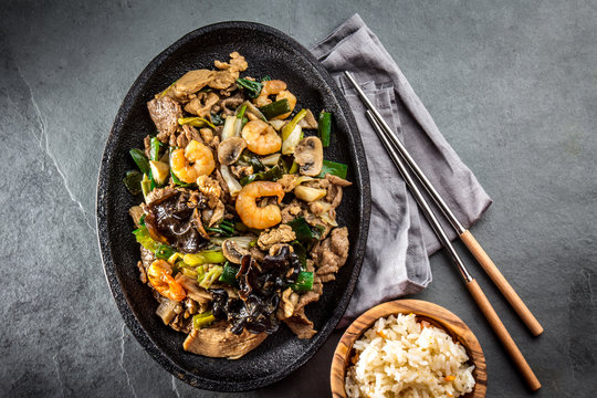Chinese food. Pan of fried beef, pork, chicken, shiitake mushrooms, prawns and spring onion