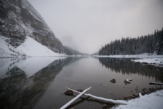 View of mountain reflected in lake during winter