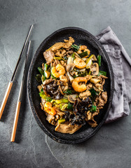 Chinese food. Pan of fried beef, pork, chicken, shiitake mushrooms, prawns and spring onion