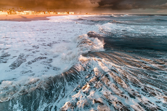 View of big waves in sea at sunset