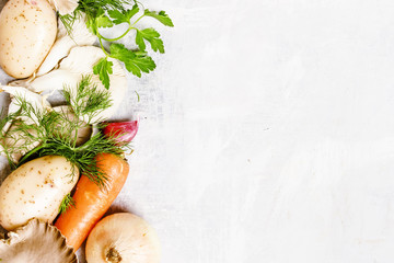 Raw potatoes, oyster mushrooms, carrots, onions, parsley, garlic and dill, food background, top view