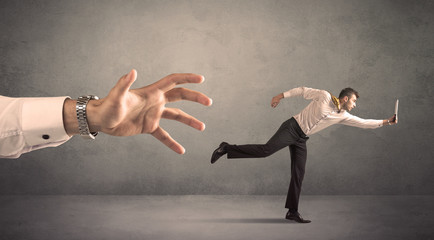Businessman running from hand