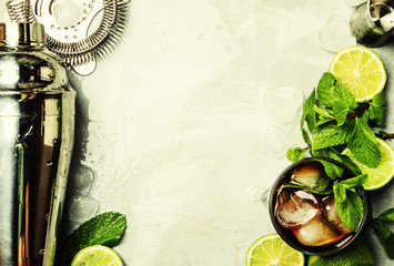 Alcoholic cocktail with rum, cola, ice and mint, bar tools, drink background, top view