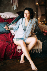 Fototapeta premium Beautiful woman with dreadlocks and tattoos. Boho style