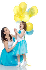 Mom and daughter with colorful balloons.