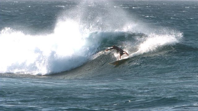 Surfer making hard turn in slow motion