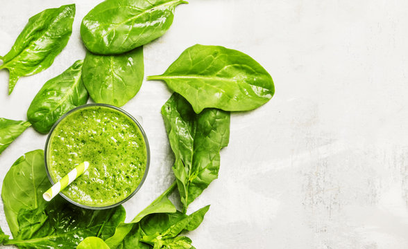 Cocktail of spinach and green vegetables and fruit, drink background, top view