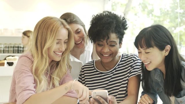 Girlfriends looking at smart phone together