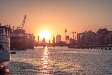 Berlin city skyline with sunset sky - river Spree, Oberbaum Bridge, Tv Tower