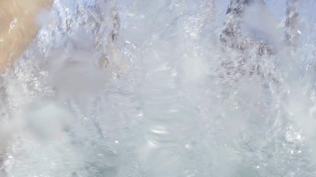 Family in swimming pool splashing each other