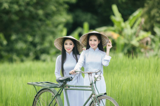 Beautiful woman in white Ao dai Vietnam Traditional dress at farmland