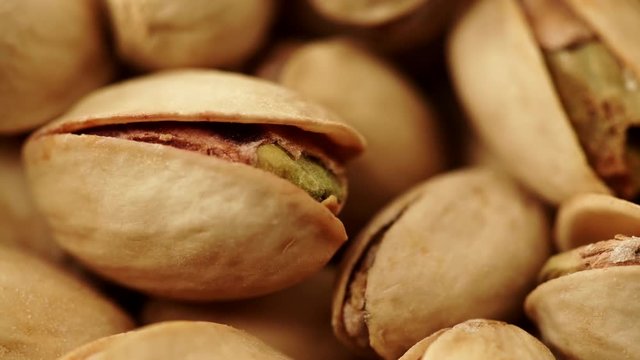 Food background. Roasted pistachio nuts seed with shell close up. Dieting concept. Dolly slider shot 4K ProRes HQ codec