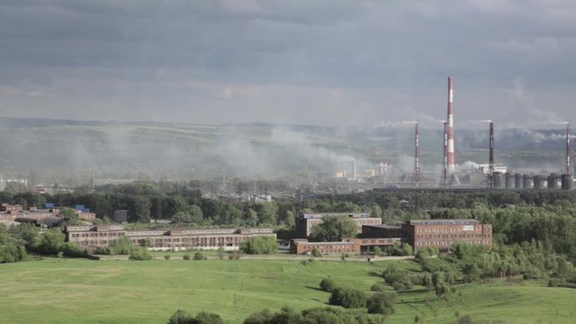 Air pollution above smole city. Pipes throwing smoke towards the city