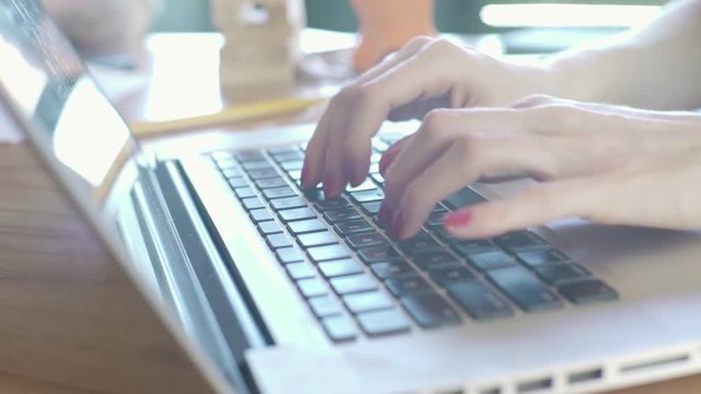Woman using laptop computer, close-up