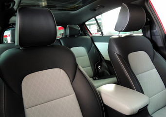 Driver and passengers seats under panoramic roof inside the vehicle at showroom
