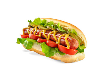 Classic Hot Dog with big sausage, fresh salad, tomatoes and pickled cucumbers isolated on white...
