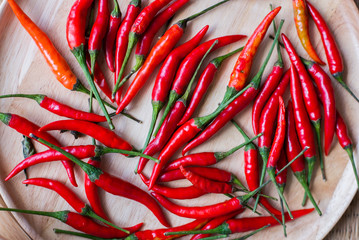 Red chili on wooden plate