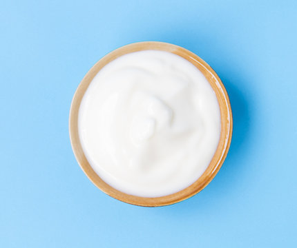 Closeup Top View Greek Yogurt Bowl With Blue Background