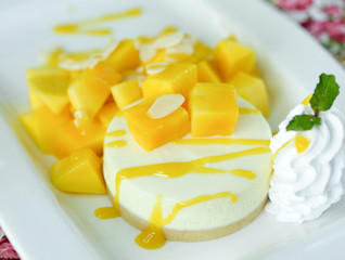 Mango cheesecake on white plate