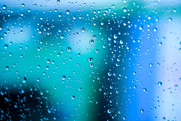 Naklejka na ściany i meble Rain drops, water drops of rain on a window glass