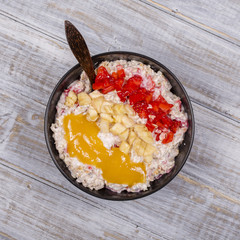 Muesli made from red strawberries, banana, chia seeds, oat flakes, honey and dressed with yogurt