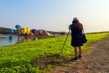 Female photographer taking Hot Air Balloon at Singha Park  Chiang Rai Balloon Fiesta, Thailand