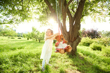 A child is playing with a swing. The concept of childhood. Children Protection Day.