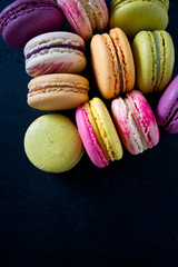 assorted macaroons on black chalkboard