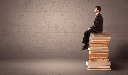 Businessman sitting on books