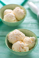 caramel ice cream on turquoise wooden background