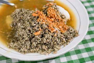 Kupang lontong kuah petis or steamed mussels with rice cake