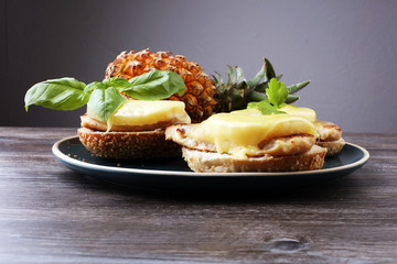 toast hawaii, , cheese and pineapple on wooden background with chicken breast