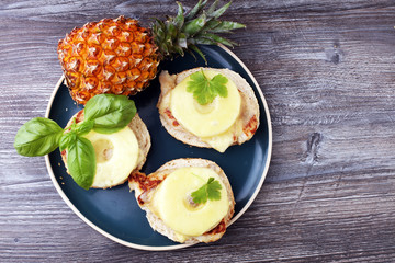 toast hawaii, , cheese and pineapple on wooden background with chicken breast