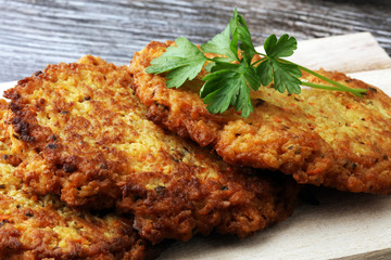 potato pancakes decorated with parsley on a cutting board on the table