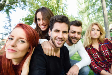 Group of friends taking selfie in urban background