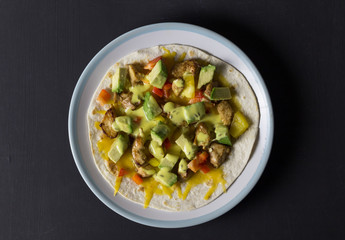 Open wrap with chicken, avocado and peppers