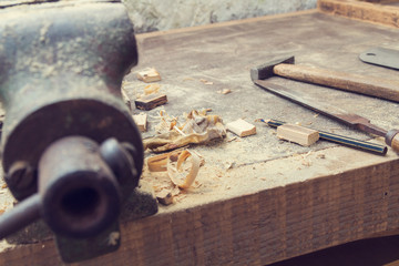 Carpenter's little working tools on a dusty table.