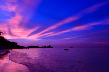 Landscape view of sunset at the beach with dramatic sky and sun light ray.