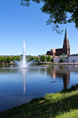 Schwerin, large fountain on the lake pfaffenteich and the Cathedrahle (dome)  in the capital city of Mecklenburg-Vorpommern, germany, tourism destination