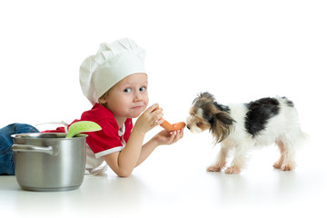 Role-playing game. Child boy playing chef with dog.
